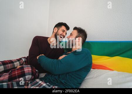 Happy gay couple having tender moments in bedroom - Homosexual love relationship and gender equality concept Stock Photo