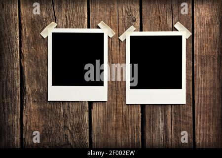 Blank instant photo frames on wooden background. Stock Photo
