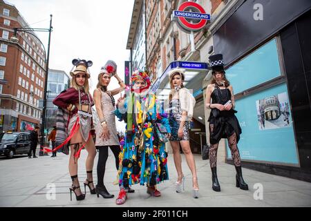 Models showcase Pierre Garroudi's latest colorful collection at one of the designer's specialty flash mob fashion shows in Bond Street,  London.
