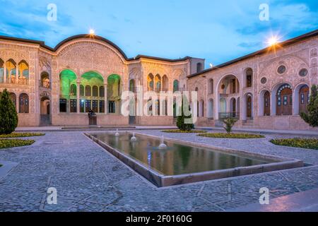 Kashan, Iran - 19.04.2019: Courtyard of the richly decorated Tabatabaei historical house. Facade with ornaments carved in amazing detail. Stock Photo