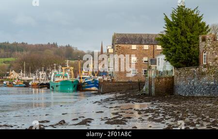 Fishing trawlers moored at Kirkcudbright harbour at lowtide in the winter, Dumfries and Galloway, Scotland Stock Photo