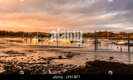Yachts and boats moored at Kirkcudbright Marina, reflecting on the water at sunset during low tide, Dumfries and Galloway, Scotlands Stock Photo