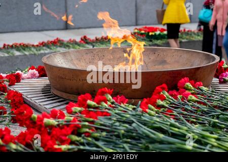 Eternal fire and flowers in memory of victims in the world war on victory day on 9 may, Grave of Unknown soldier, Kremlin wall. Moscow, Russia. Stock Photo