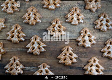 Christmas cookies in the shape of a Christmas tree. New Year's food. Anise star. Festive baked goods. Gingerbread on the table. Pattern. Stock Photo