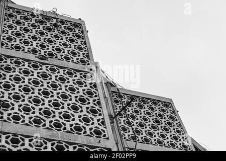 A greyscale low angle shot of a building with a patterned facade Stock Photo