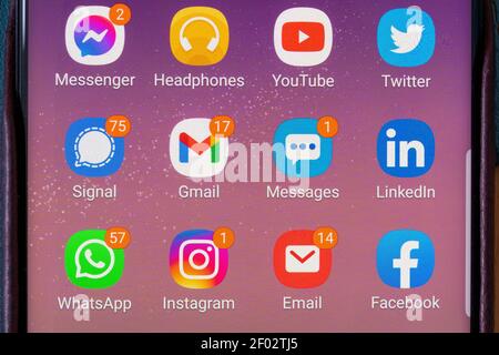 A closeup on an Android smartphone screen showing several apps with unread messages and new notifications. Concept addiction, addictive, social media Stock Photo