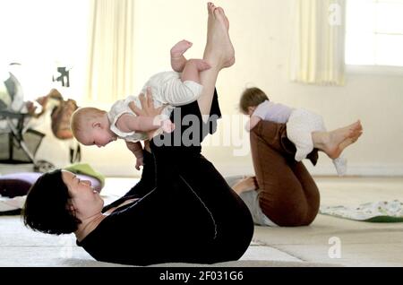 Bella Shing balances 6 month old Josey on her legs during Momma