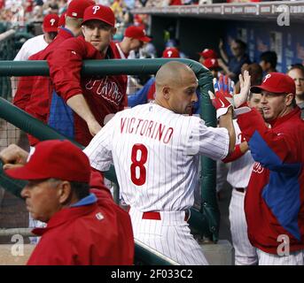 The Philadelphia Phillies' Shane Victorino (18) is safe at first as New  York Yankees first baseman Jason Giambi leaps but can't catch an overthrow  by second baseman Robinson Cano in the fourth