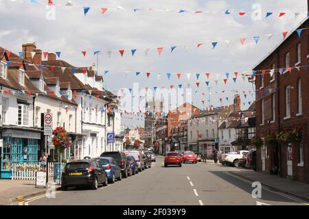 Alcester High Street, Shakespeare Country, Warwickshire, UK, in the summer with red, white and blue bunting across the street. Stock Photo