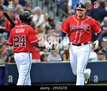 The Atlanta Braves' Chipper Jones is congratulated by teammate Freddie  Freeman (5) after his solo home run in the second inning against the Los  Angeles Dodgers at Turner Field in Atlanta, Georgia