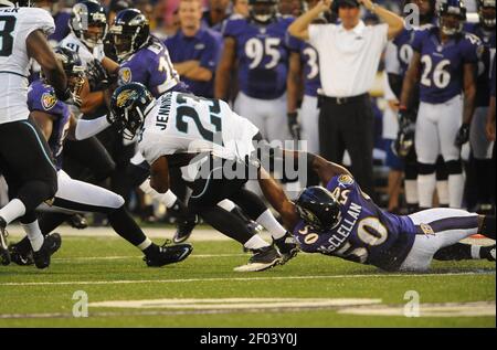 Jacksonville Jaguars running back Rashad Jennings (23) wards off New York  Giants linebacker Clint Sintim (52) on a long run into the red zone during  first half week 12 NFL action between