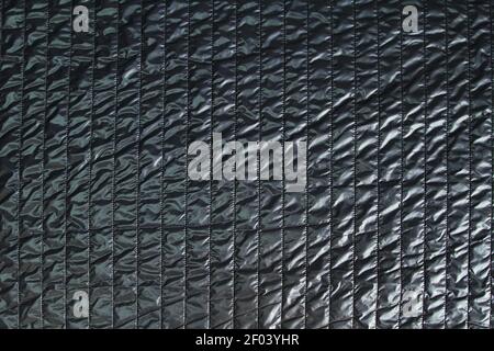 Dark fashionable quilted fabric in black. Stock Photo