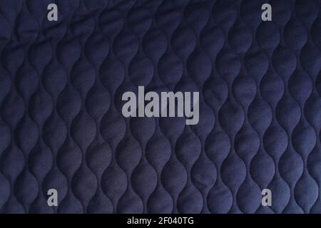 Fashionable quilted fabric in dark blue color. Abstract dark blue background . Stock Photo