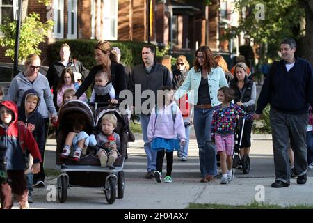 Parents walk their children to Alexander Graham Bell Elementary School, 3730  N. Oakley Avenue in Chicago, Illinois, Wednesday, September 19, 2012, on  the first day back to school after the teachers' strike. (