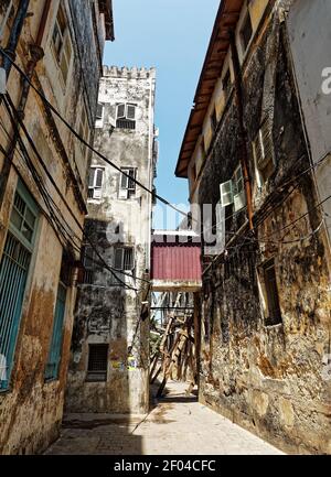 Stonetown (Tanzania, Zanzibar Archipelago). Streets and harbour in old Stone Town of Zanzibar City, historical colonial stony buildings, narrow street Stock Photo