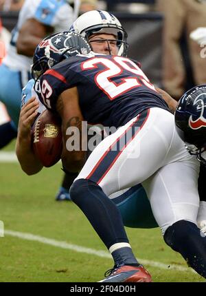 J.J. Watt (99) of the Houston Texans forces quarterback Jake Locker (10) of  the Tennessee Titans to scramble in the first half of their game on Sunday,  September 15, 2013, in Houston