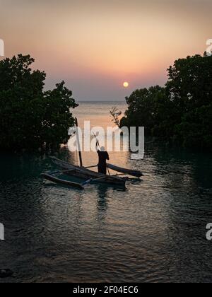 Zanzibar Island coast (Tanzania, Zanzibar Archipelago). Typical local aboriginal boats in the evenind and the dusk. Ocean with the sailing boat. Stock Photo