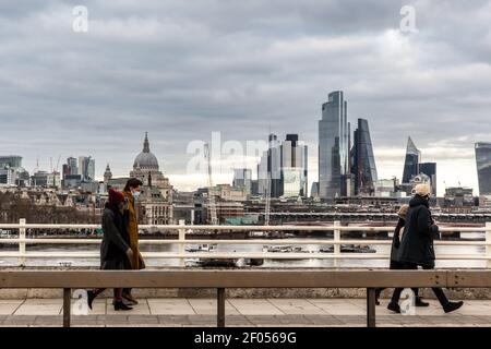London, UK, March 6, 2021. Londoners are seen walking in Southbank by the Thames river while the setting sun covers The City of London and St Paul's Cathedral during an ongoing third Coronavirus lockdown. The Prime Minister Boris Johnson have set a road map on easing the restrictions. Credit: Dominika Zarzycka/Alamy Live News
