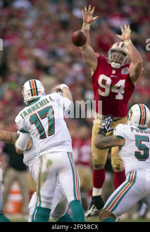 Miami Dolphins quarterback Jacoby Brissett (14) tries to hold off an attack  by Buffalo Bills defensive tackle Justin Zimmer (61) during the second half  of an NFL football game, Sunday, Sept. 19