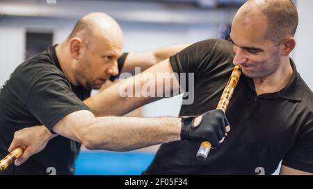 Escrima and kapap instructor demonstrates sticks fighting