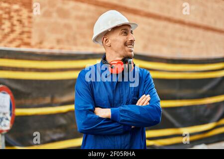 Young caucasian worker smiling happy wearing uniform at the city. Stock Photo