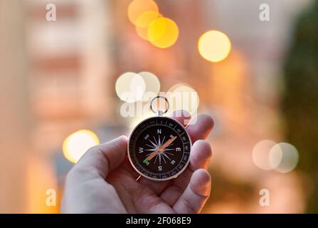 Closeup of hands holding a compass Stock Photo