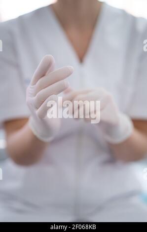 Crop unrecognizable female doctor in medical uniform demonstrating ...