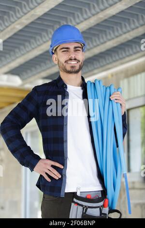 plumber with tool belt on white background Stock Photo
