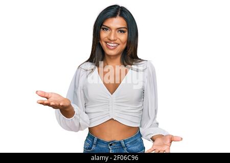 Young latin transsexual transgender woman wearing casual clothes smiling cheerful with open arms as friendly welcome, positive and confident greetings Stock Photo