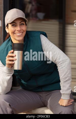 portrait of happy young female construction worker having coffee Stock Photo