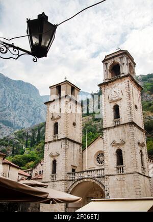 The ancient buildings and architecture of Old Town Kotor surrounding the main square which sits beyond the sea gate or entrance to Kotor. Stock Photo