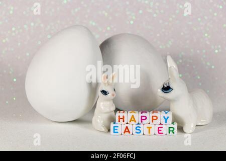 Happy Easter Bunnies With Large White Eggs Stock Photo