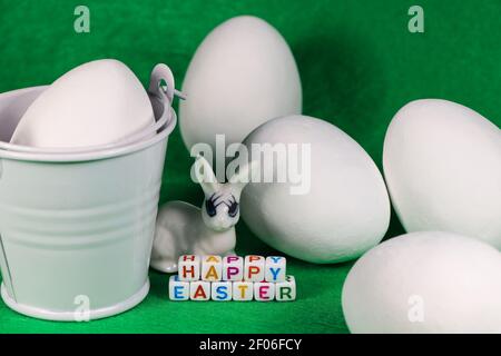 Happy Easter Bunny With Large White Eggs And Bucket Stock Photo