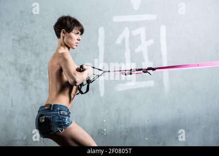 TRX. Beautiful girl in the gym Stock Photo
