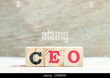 Alphabet letter block in word CEO (Abbreviation of Chief Executive Officer) on wood background Stock Photo
