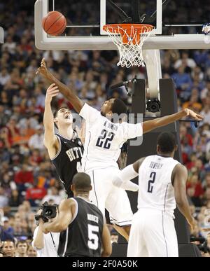 Butler center Andrew Smith (44) puts up a go-ahead score against Pittsburgh  guard Ashton Gibbs (12) with only seconds remaining in a third-round game  of the 2011 NCAA Men's Basketball Championship tournament