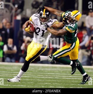 Green Bay Packers cornerback Pat Lee (R) dives to tackle Pittsburgh Steelers  running back Rashard Mendenhall in the third quarter during Super Bowl XLV  at Cowboys Stadium in Arlington, Texas on February