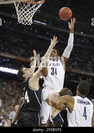 Butler center Andrew Smith (44) puts up a go-ahead score against Pittsburgh  guard Ashton Gibbs (12) with only seconds remaining in a third-round game  of the 2011 NCAA Men's Basketball Championship tournament