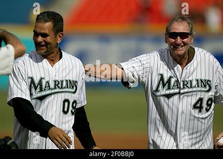 Former Florida Marlins Charlie Hough, left, and Benito Santiago, of Puerto  Rico, congratulate each other after Hough threw a ceremonial first pitch to  Santiago before the start of a baseball game between
