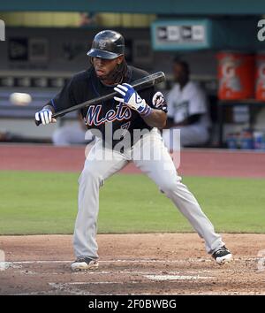 Miami Marlins Jose Reyes motions his team mates after sliding into second  base against the New York Yankees at the new Miami Marlins Ball Park in the  second exhibition game April 2