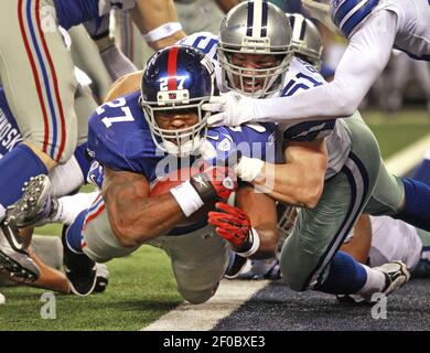 Dallas Cowboys middle linebacker Keith Brooking (51) and Dallas Cowboys  cornerback Orlando Scandrick (32) bring down Tampa Bay Buccaneers tight end  Zack Pianalto (80). The Cowboys defeated the Buccaneers 31-15 in an