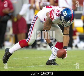 New York Giants linebacker Michael Boley (59) celebrates with safety Kenny  Phillips (21) after Phillips broke up a passing play during first half NFL  action between the New York Giants and the