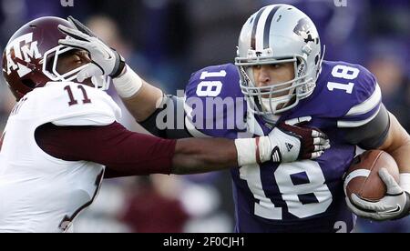 Andre McDonald (18) of Kansas State pulls in a touchdown pass late the  first half as Jake Bequette of Arkansas defends in the Cotton Bowl at  Cowboys Stadium in Arlington, Texas, on