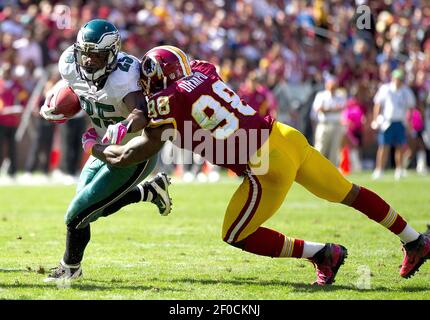 Dec. 24, 2011 - Landover, Maryland, U.S - Minnesota Vikings running back  Adrian Peterson (28) fights to break a tackle by Washington Redskins  outside linebacker Brian Orakpo (98) during Saturday afternoon's game