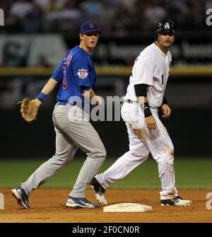 Chicago Cubs second baseman DJ LeMahieu (33) is charged with an error in  the second inning that allowed Milwaukee Brewers right fielder Corey Hart  (1) to get to first base at Wrigley