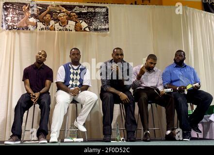 NBA basketball player LeBron James, third from right, poses with his high  school basketball coach and teammates, from left, Dru Joyce II, Lil' Dru  Joyce III, Sian Cotton, Willie McGee and Romeo Travis at the premiere of  the Peacock film Shooting Stars