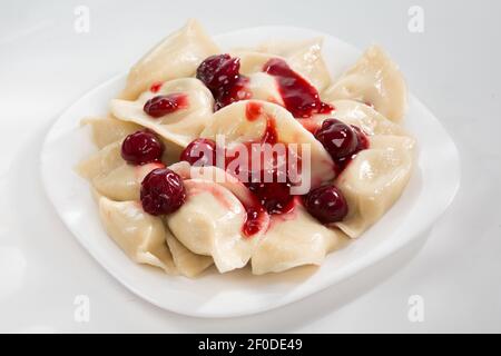 Homemade traditional Ukrainian dumplings, vareniki with cherries Stock Photo