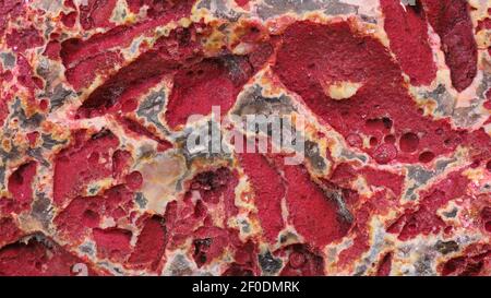 Untreated surface of a red agate, natural quartz stone texture, mineral stone background Stock Photo