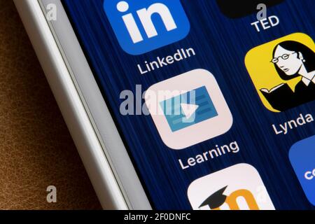 LinkedIn Learning app icon is seen next to Lynda.com app on an iPhone. Lynda.com has been completely migrated over to LinkedIn Learning as of 2019. Stock Photo