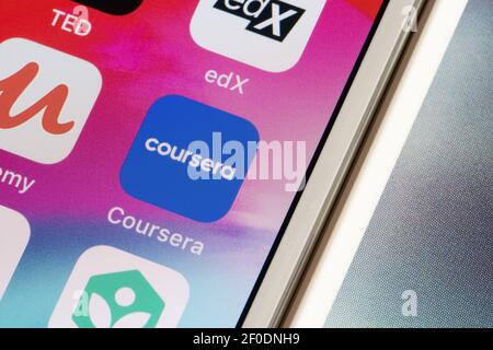 Coursera mobile app icon is seen on an iPhone. Coursera is an American massive open online course provider founded by Andrew Ng and Daphne Koller. Stock Photo